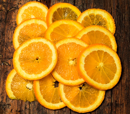 orange slices on top of a rustic table. Foreground.の写真素材