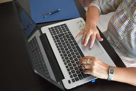Hands of mature age professional woman doing office tasks. Mexico City. April 11, 2020