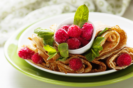 Pancake rolls with fresh raspberry and mintの写真素材