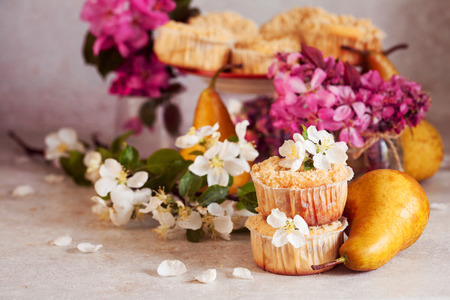 Homemade pear and caramel muffins in paper cupcake holder with flowersの写真素材