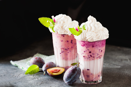 Plum milkshake cocktail decorated with mint and whipped creamの写真素材