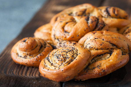 Braided pie with poppy seeds on rustic board close upの写真素材