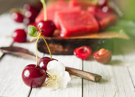 Cherry marmalade with berries on the old wooden boardの写真素材