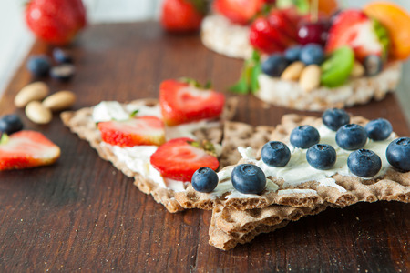 Healthy rie cakes with soft cheese and berries, close upの写真素材