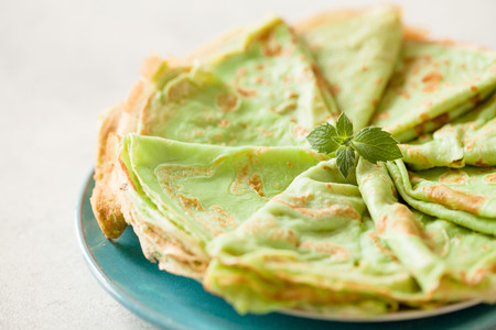 Japaneese matcha crepes with mint on black slate background copy spaceの写真素材