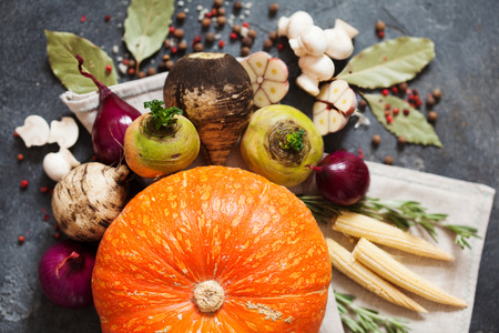 Fresh vegetables and spices for vegan soup. Pumpkin, turnip, radish, onion, champignon, corn, garlic...