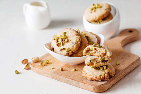 Butter cookies with pistachios on wooden board close upの写真素材