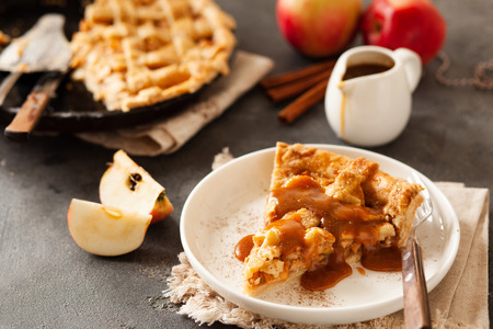 Slice of freshly baked apple pie with caramel sauce and cinnamon, closeup copy spaceの写真素材