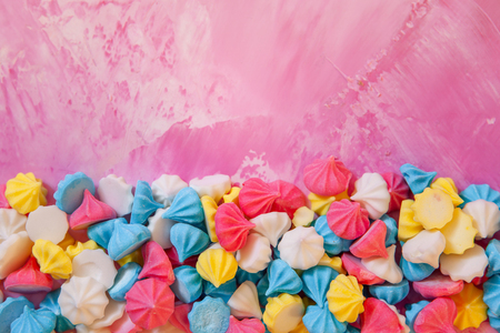 Pastel colored merengues cookies on pink background top viewの写真素材