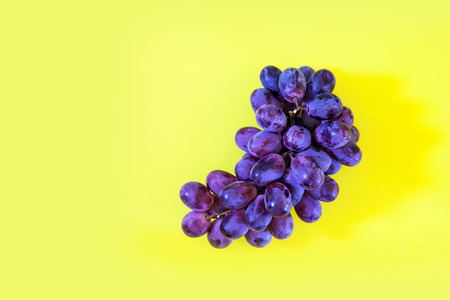 Ripe sweet grape bunch on bright yellow background top view, copy spaceの写真素材