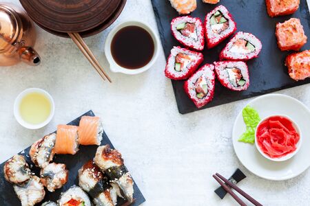 Japanese sushi set nigiri and sushi rolls served with wasabi and ginger, top viewの写真素材