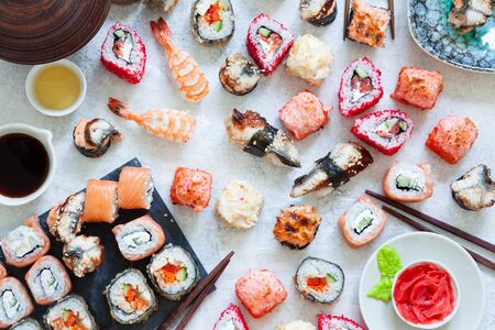 Japanese sushi set nigiri and sushi rolls served with wasabi and ginger, top viewの写真素材