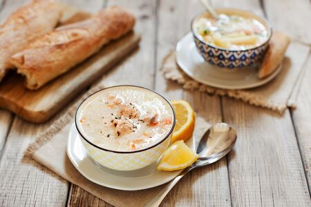 Creamy fish Soup with salmon, cream and potatoes in a bowl traditional soup in Nordic countriesの写真素材