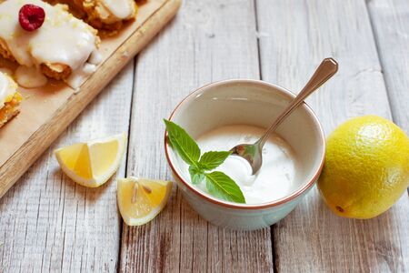 Close up of lemon frosting in blue bowl for decoration cakesの写真素材