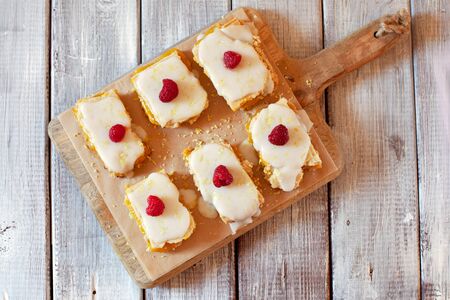 Top view of lemon portion cake slices decorated with raspberry and lemon zestの写真素材