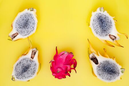 Yellow and pink dragon fruit on bright background top viewの写真素材
