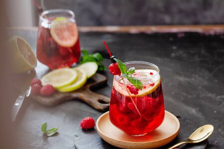 Sparkling pink raspberry lemonade on dark background, summer refreshing drinkの写真素材