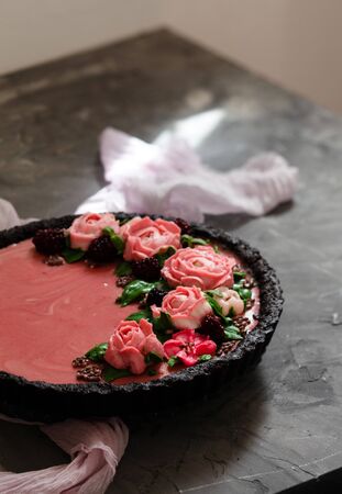 Summer berry tart decorated with fresh blackberries and cream cheese flowersの写真素材
