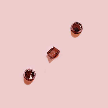 Chocolate praline with toffee filling pattern on pink backgound, chocolate backdropの写真素材