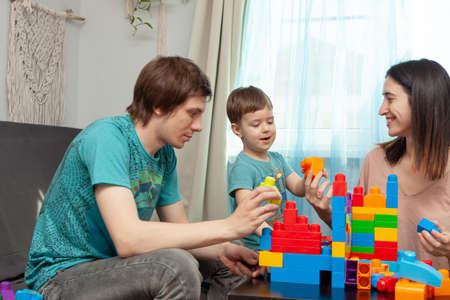 Dad mom and son playing in the constructor. The concept of self-isolation to combat Covid-19. Happy familyの写真素材