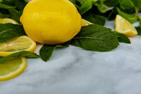 Summer background composition with lemon slices, leaves and mint. Minimal lemonade drink concept. Top viewの写真素材