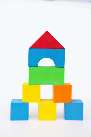 Toy house on a white background. A house made of color bricks. With space for writingの写真素材