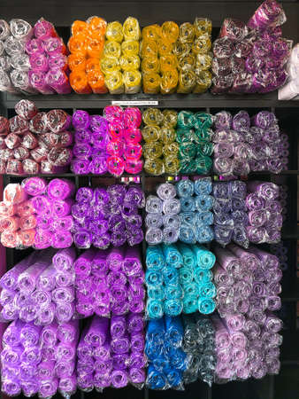 Colorful rolls of paper are spread out on the shelf. Accessories for flower shops. Multi-colored wrapping paper.の写真素材