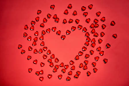 Valentines day hearts background. Many colorful hearts - valentine background. Beautiful decorative heart shaped on red background, valentines day conceptの写真素材