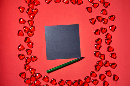a blank piece of paper for a note. Valentines day hearts background. Many colorful hearts -...