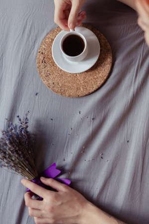 Very pretty redhead girl with dreads on bed in bedroom in the morning. A feminine, gentle girl. Coffee morning concept.の写真素材