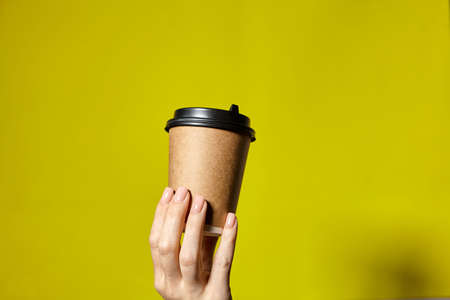 Hands holding two cups brown paper with black lid. Two coffee special offer or promo. Hands holding...