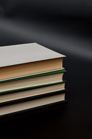 Stack of colorful books. An open book on a stack of books. The concept of education, international book day, success. Book, hardback colorful books on table. Education business concept.の写真素材