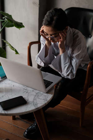 Business asian woman working on laptop and reading required information, look like serious and...