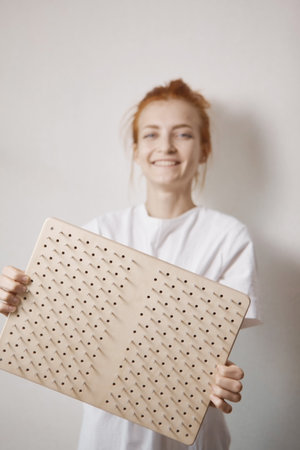 A woman holds a board with nails in her hands. Sadhu yogaの写真素材