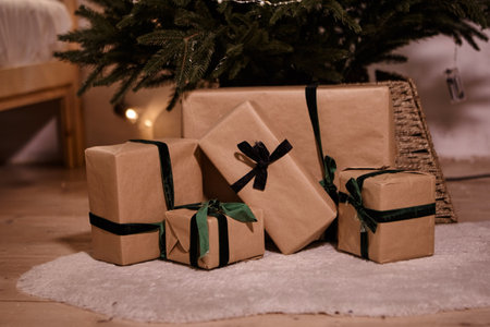 Beautiful Christmas gift boxes on floor near fir tree in room. Christmas Home Interior White Christmas treeの写真素材