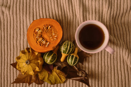 Cup hot tea on the gray table with pumpkin, leaves, spices on the background. Autumn concept. Top view. High quality footageの写真素材
