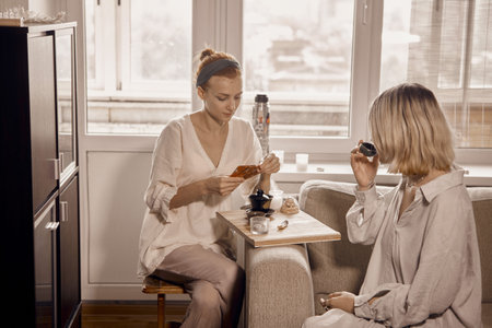 Two women are drinking tea while conducting a Chinese tea ceremony and talking.の写真素材