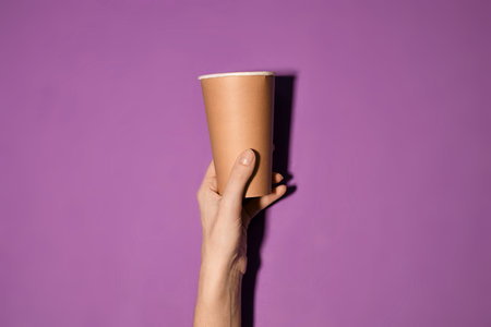Wooden spoon, fork, paper cups gray background. Disposable tableware made of natural materials. The concept of a zero waste, sustainable lifestyle. Eco-friendly disposable tablewareの写真素材