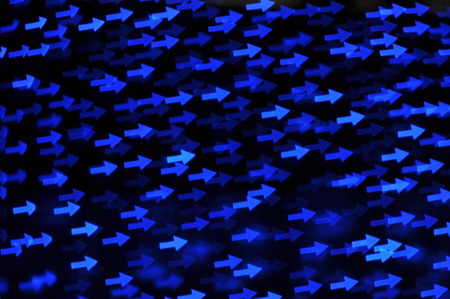 Beautiful holiday background with blue arrows  defocused lightsの写真素材