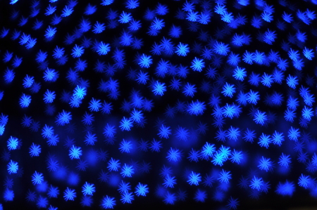 Beautiful holiday background with blue stars defocused lightsの写真素材