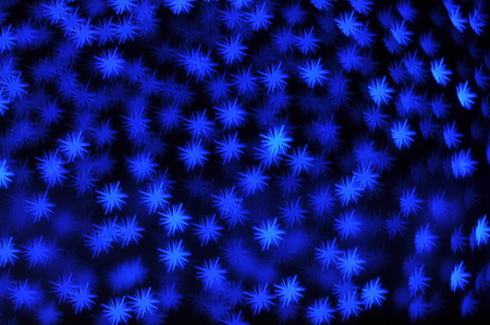 Beautiful holiday background with blue stars defocused lightsの写真素材