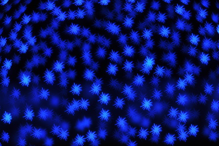 Beautiful holiday background with blue stars defocused lightsの写真素材