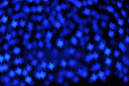 Beautiful holiday background with blue stars defocused lightsの写真素材