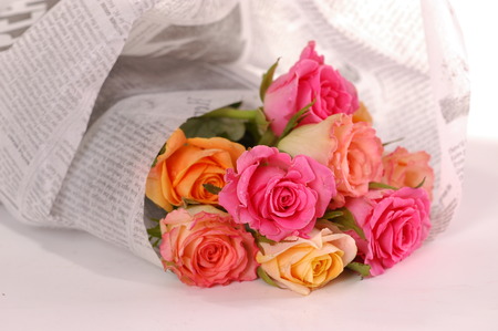 Beautiful bouquet of roses wraped in a newspaperの写真素材