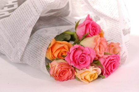 Beautiful bouquet of roses wraped in a newspaperの写真素材