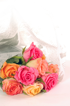Beautiful bouquet of roses wraped in a newspaperの写真素材