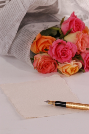 Beautiful bouquet of roses wraped in a newspaperの写真素材