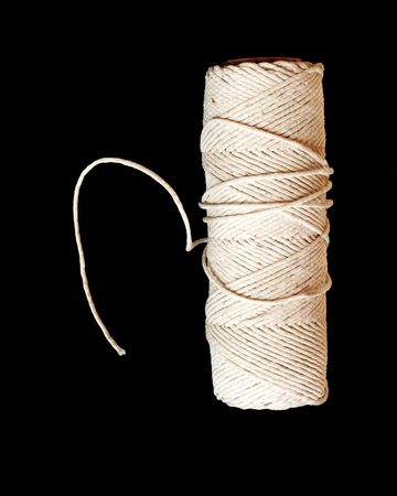 Roll of string on black background.の写真素材