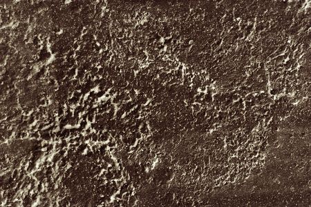Detail of textured and crystallized cement painted brown.