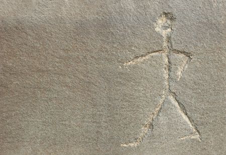 Carving of a stick man on stone.の写真素材